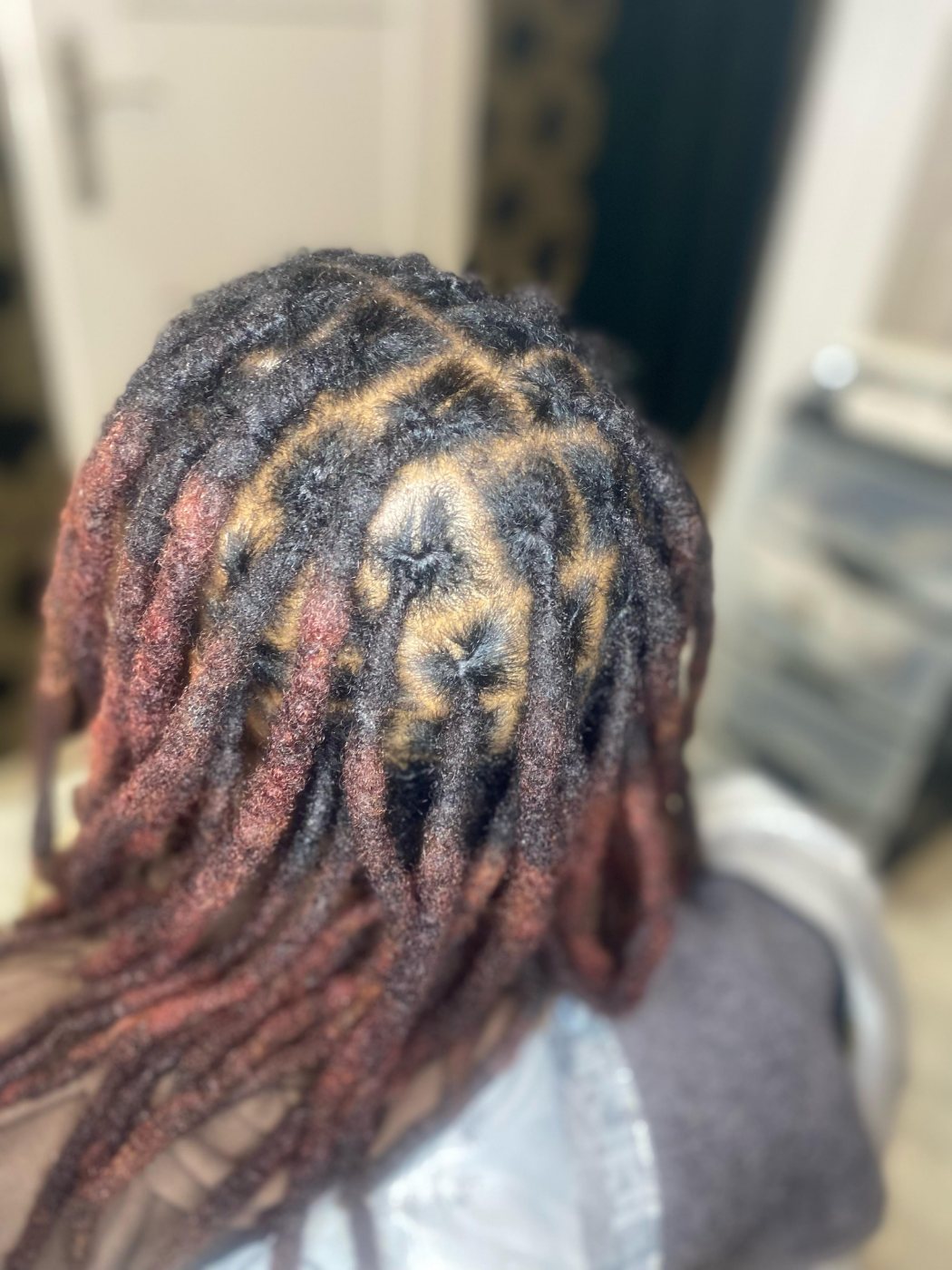 Coloured locs with a freshly retouched crown, done at The Honey Lounge